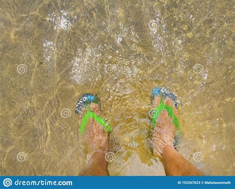 A Pair Of Legs With Sandal Under Water A Under Water Background