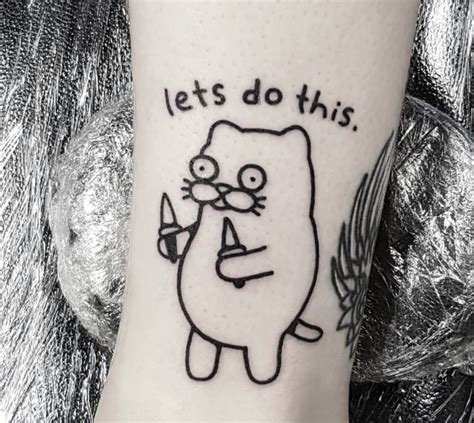 A Cartoon Character Tattoo On The Ankle With Words That Says Lets Do This