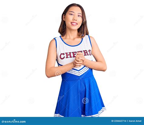 Young Beautiful Chinese Girl Wearing Cheerleader Uniform With Hands