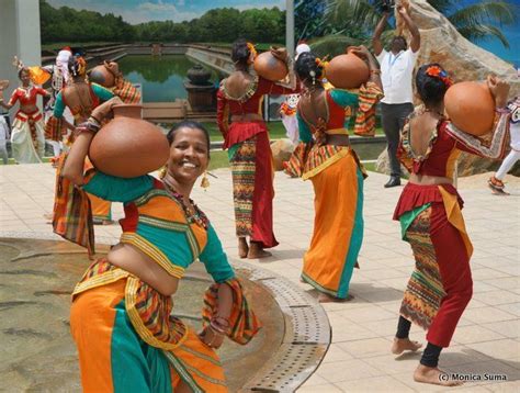 A Group Of Women In Colorful Outfits Dancing