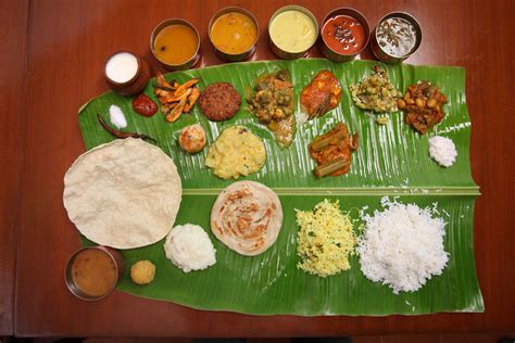 A Banana Leaf With Different Types Of Food And Condiments On It
