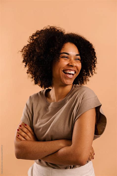 Lively Woman With Afro Curly Hair Studio Portrait By Stocksy