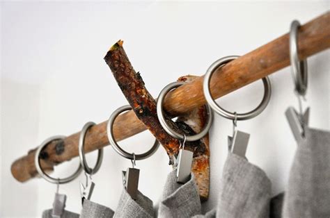 Several Pieces Of Wood Hanging From Hooks On A Wall With Metal Rings