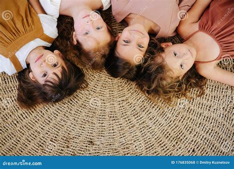 Four Little Girls About The Same Age Lying On The Floor Head To Head