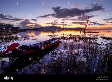 Beautiful Sunset Sky And Wood Boat Floating In Bangpra Water Reservoir