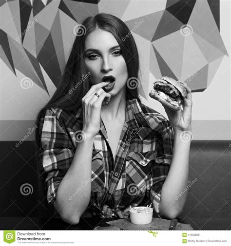 beautiful woman holding burger and licking her finger stock image image of cuisine fried