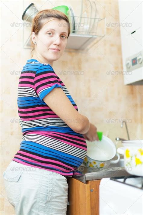 Pregnant Woman Washes Dishes Pregnant Women Women Pregnant