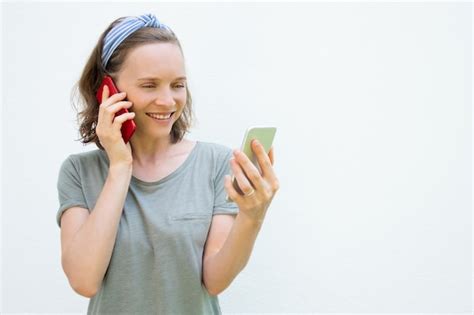Free Photo Happy Busy Young Woman Using Two Mobile Phones