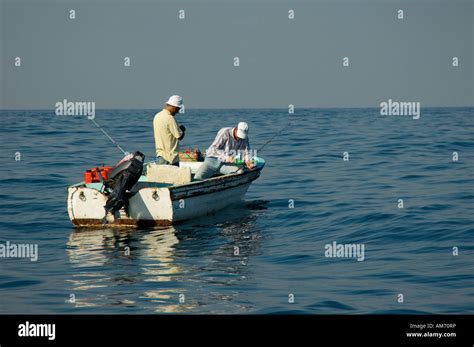 Two Mature Men In A Fishing Boat Stock Photo Alamy