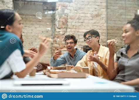 Dream Team Group Of Positive Young Coworkers Eating Pizza