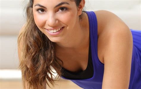 A Woman In Blue Shirt Laying On The Ground