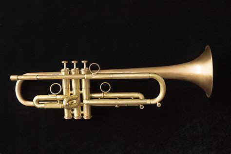 A brass musical instrument consisting of a metal tube with one narrow end, into which the player…. Lawler C7 Trumpet (B flat) | Reverb