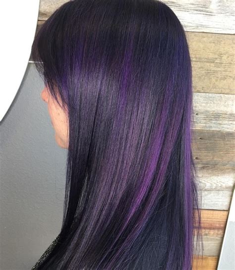 Purple can be worn in many different ways, whether you want a few piecey highlights or completely douse your tresses in a deep electric purple hue. Purple highlights on dark hair is the latest Instagram trend