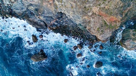 Download Wallpaper 2048x1152 Rock Sea Stones Aerial View Ultrawide