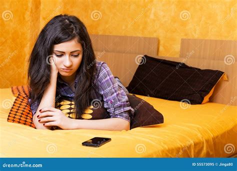 Pretty Teenage Girl Lying In Bed An Looking At Her Phone With Sa Stock Image Image Of Cell