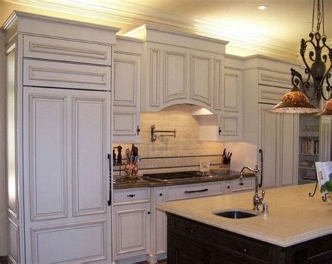 Crown molding that sits atop kitchen cabinets gives them a solid finished look. How to Install a Crown Molding to Kitchen Cabinets ...