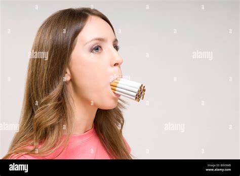 Woman With Multiple Cigarettes In Mouth Stock Photo Alamy