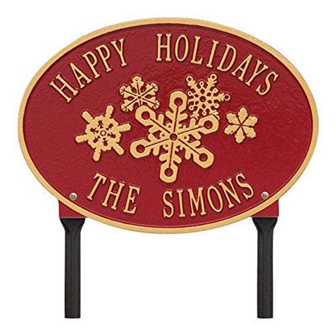 A Red And Gold Sign That Says Happy Holidays The Simons With Snowflakes