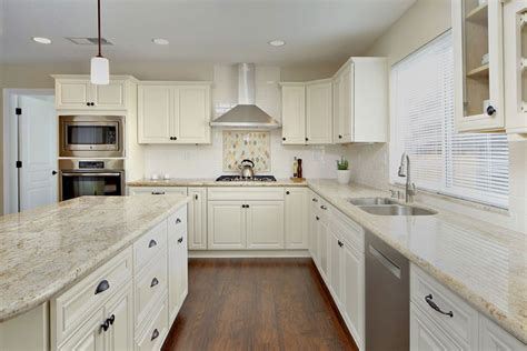 Kitchen color schemes with white cabinets are often partnered with red or blue accents for a classic color palette. River White Granite Countertops (Pictures, Cost, Pros & Cons)