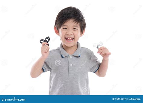 asian chld holding two fidget spinners stock image image of disorder happy 95494347