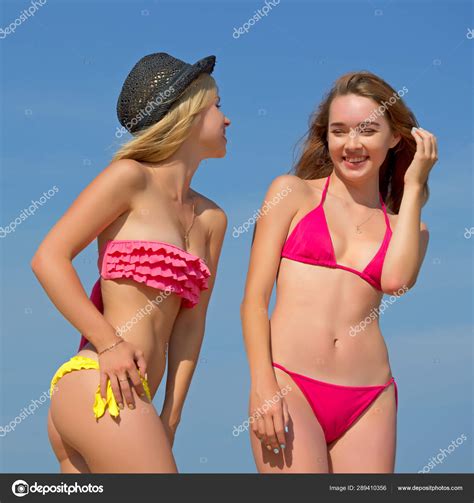 Two Blue Bikinis Laid Side By Side On A White Background Stock Photo