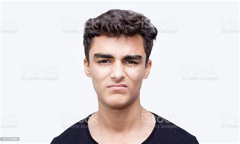 Portrait Of Young Man In Disgust Expression Over White Background Stock