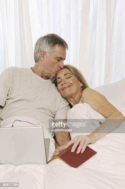 mature couple kissing in bed stockfoto s en beelden getty images