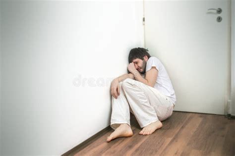Lonely Sad Man Suffers From Depression And Crying On Floor Stock Image