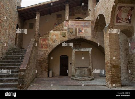 pretty courtyard in the palazzo del popolo with fresco fragments by sodoma san gimignano