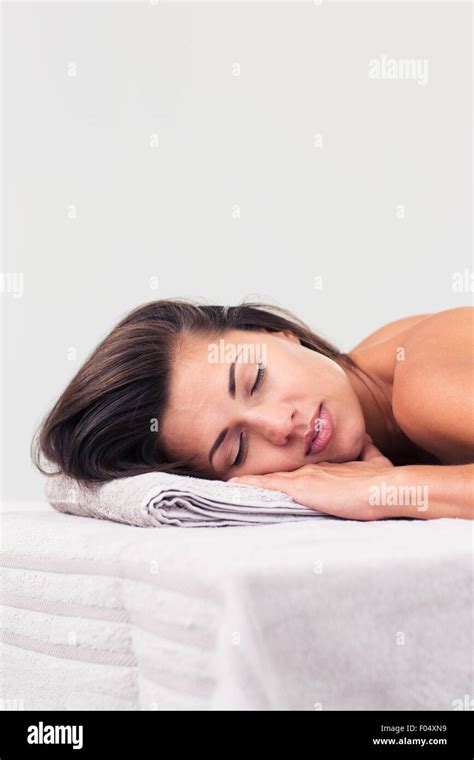 Beautiful Woman Sleeping On Massage Lounger In A Wellness Center Isolated On A White Background