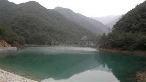 Turquoise Lake Surrounded With Green Mountains In Asia China Stock