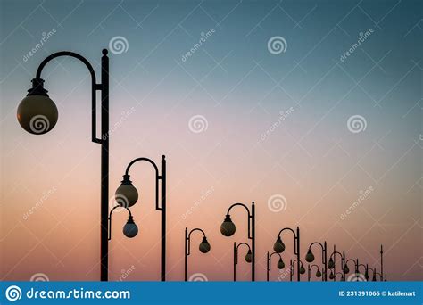Sunset Sky Over A Row Of Street Lamps Stock Photo Image Of Twilight