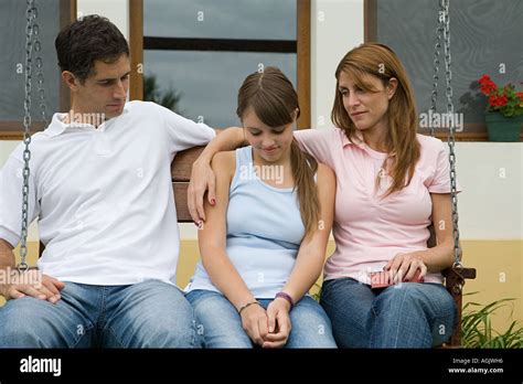 Parents Comforting Daughter Stock Photo Alamy