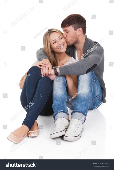 Young Couple In Love Sitting Close Together On The Floor
