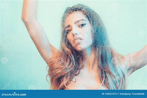 Beautiful Woman In The Shower Behind Glass With Drops Stock Image
