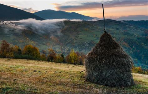 Majestic Sunrise In Misty Morning Valley With Haystack On