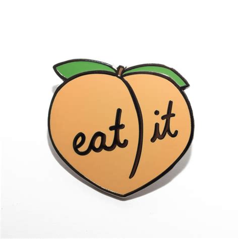 An Orange Shaped Pin With The Words Eat It On It S Front And Back