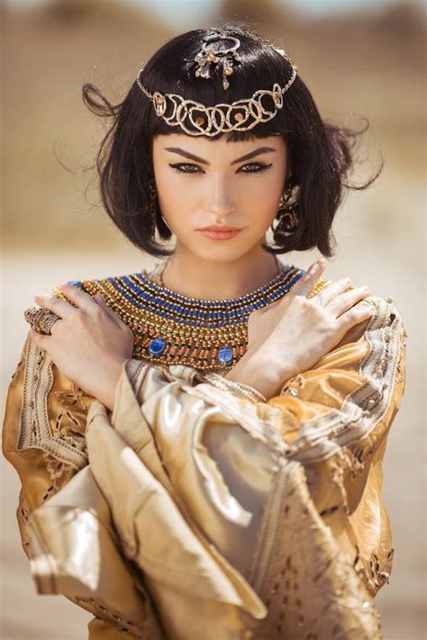 beautiful woman with fashion make up and hairstyle like egyptian queen cleopatra outdoors