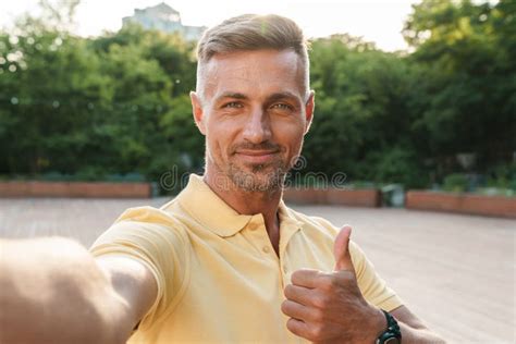 Image Closeup Of Smiling Middle Aged Man Taking Selfie Photo With Thumb