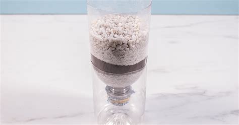 Pour the dirty water into the filter: Crafts for Kids: DIY Water Filter