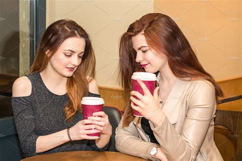 Two Young Girls Talking In A Cafeteria High Quality People Images