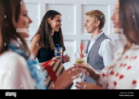 Group Of People Celebrating Talking Drinking Cocktails Stock Photo