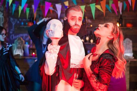 Premium Photo Human Skeleton Holded By Beautiful Woman Dressed Up Like A Sexy Vampire For