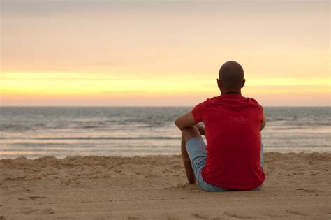 Young Man Sitting In The Beach Sand People Photos On Creative Market