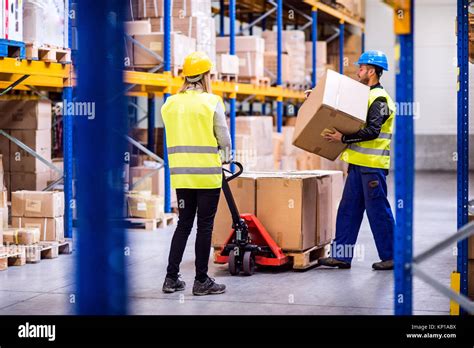 Young workers in a warehouse Stock Photo - Alamy