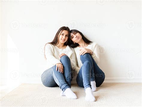 Two Female Best Friends Sitting Together At Home Stock Photo At