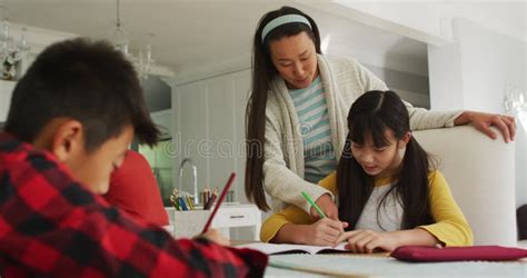Asian Mom Is Helping Her Son To Do Homework Stock Video Video Of