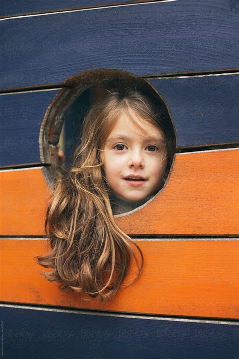 Girl Playing Peeking From Hole Del Colaborador De Stocksy Dejan Ristovski Stocksy