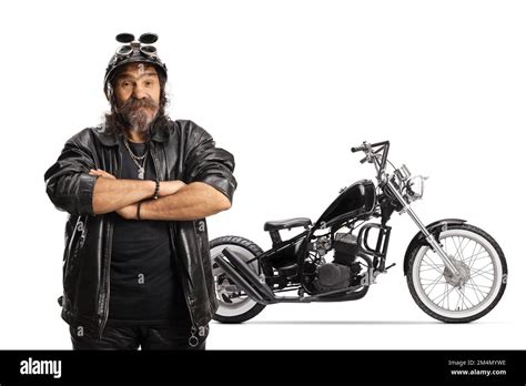 Mature Bearded Biker With A Helmet And Leather Jacket In Front Of A