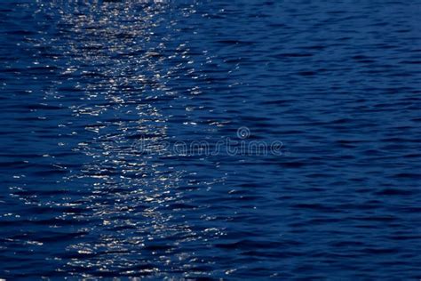 Blue Sea At The Evening With Moonlight Reflection Stock Photo Image